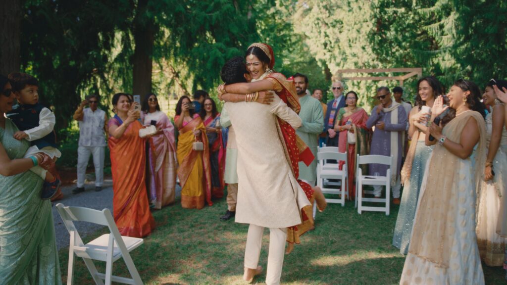 Joyful Indian Bride being picked up by her groom